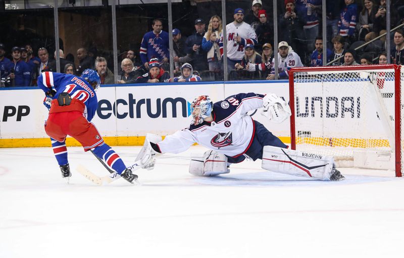 Jan 18, 2025; New York, New York, USA; Columbus Blue Jackets goalie Daniil Tarasov (40) reaches out to stop a shot by New York Rangers left wing Artemi Panarin (10) in a shootout at Madison Square Garden. Mandatory Credit: Danny Wild-Imagn Images