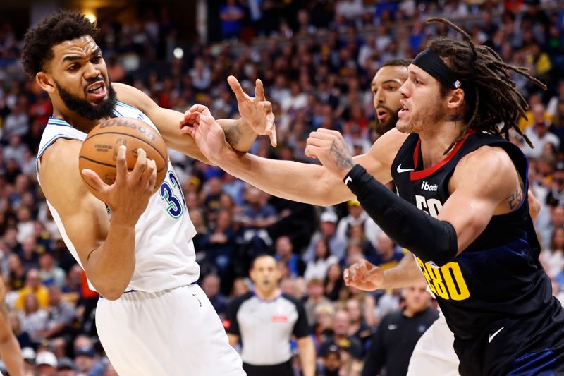 DENVER, COLORADO - MAY 19: Karl-Anthony Towns #32 of the Minnesota Timberwolves rebounds the ball against Aaron Gordon #50 of the Denver Nuggets during the second quarter in Game Seven of the Western Conference Second Round Playoffs at Ball Arena on May 19, 2024 in Denver, Colorado. NOTE TO USER: User expressly acknowledges and agrees that, by downloading and or using this photograph, User is consenting to the terms and conditions of the Getty Images License Agreement. (Photo by C. Morgan Engel/Getty Images)