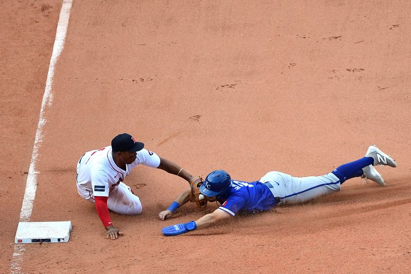 Jul 14, 2024; Boston, Massachusetts, USA;  Boston Red Sox third baseman Rafael Devers (11) tags out Kansas City Royals center fielder Garrett Hampson (2) during the ninth inning at Fenway Park. Mandatory Credit: Bob DeChiara-USA TODAY Sports