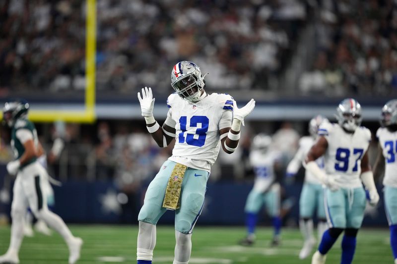 Dallas Cowboys linebacker DeMarvion Overshown (13) celebrates after sacking Philadelphia Eagles quarterback Jalen Hurts in the first half of an NFL football game in Arlington, Texas, Sunday, Nov. 10, 2024. (AP Photo/Jeffrey McWhorter)