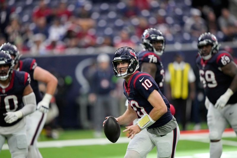 Houston Texans quarterback Davis Mills scrambles out of the pockets during an NFL football game against the Cleveland Browns Sunday, Dec. 24, 2023, in Houston. (AP Photo/David J. Phillip)