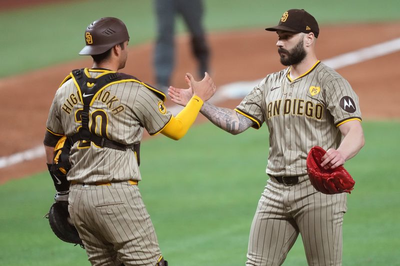 Aug 10, 2024; Miami, Florida, USA;  San Diego Padres catcher Kyle Higashioka (20) congratulates pitcher Trevor Scott (61) on a victory against the Miami Marlins at loanDepot Park. Mandatory Credit: Jim Rassol-USA TODAY Sports