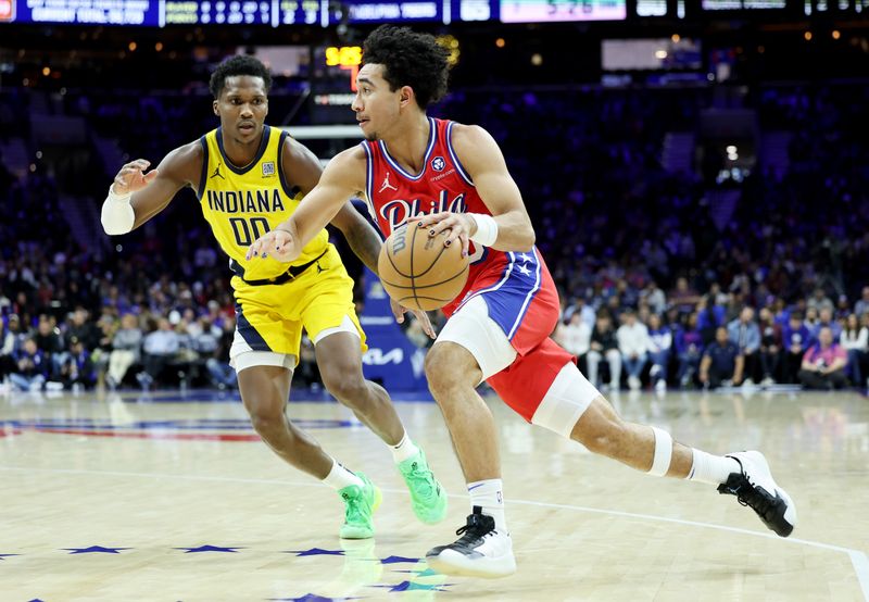 PHILADELPHIA, PENNSYLVANIA - DECEMBER 13: Jared McCain #20 of the Philadelphia 76ers drives against Bennedict Mathurin #00 of the Indiana Pacersduring the second half at the Wells Fargo Center on December 13, 2024 in Philadelphia, Pennsylvania. NOTE TO USER: User expressly acknowledges and agrees that, by downloading and or using this photograph, User is consenting to the terms and conditions of the Getty Images License Agreement. (Photo by Emilee Chinn/Getty Images)