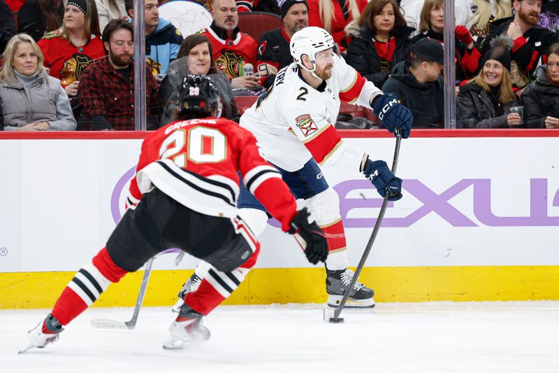 Jan 25, 2026; Chicago, Illinois, USA; Florida Panthers defenseman Jeff Petry (2) passes the puck against Chicago Blackhawks center Ryan Greene (20) during the first period at United Center. Mandatory Credit: Kamil Krzaczynski-Imagn Images
