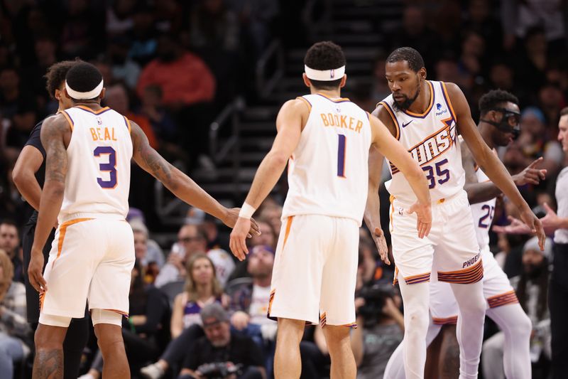 PHOENIX, ARIZONA - DECEMBER 13: Kevin Durant #35 of the Phoenix Suns high fives Bradley Beal #3 and Devin Booker #1 during the second half of the NBA game against the Brooklyn Nets at Footprint Center on December 13, 2023 in Phoenix, Arizona. The Nets defeated the Suns 116-112. NOTE TO USER: User expressly acknowledges and agrees that, by downloading and or using this photograph, User is consenting to the terms and conditions of the Getty Images License Agreement.  (Photo by Christian Petersen/Getty Images)