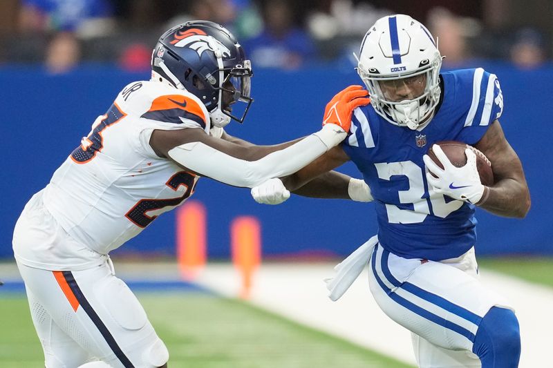 Indianapolis Colts running back Trent Pennix (36) carries the ball against Denver Broncos linebacker Andre Smith during the fourth quarter of a preseason NFL football game, Sunday, Aug. 11, 2024, in Westfield, Ind. (AP Photo/Darron Cummings)