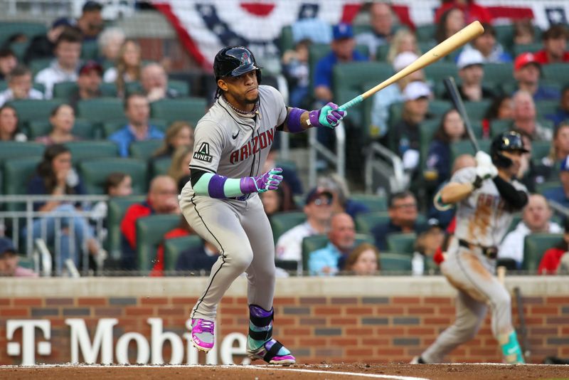 Apr 6, 2024; Atlanta, Georgia, USA; Arizona Diamondbacks second baseman Ketel Marte (4) hits a RBI double against the Atlanta Braves in the first inning at Truist Park. Mandatory Credit: Brett Davis-USA TODAY Sports