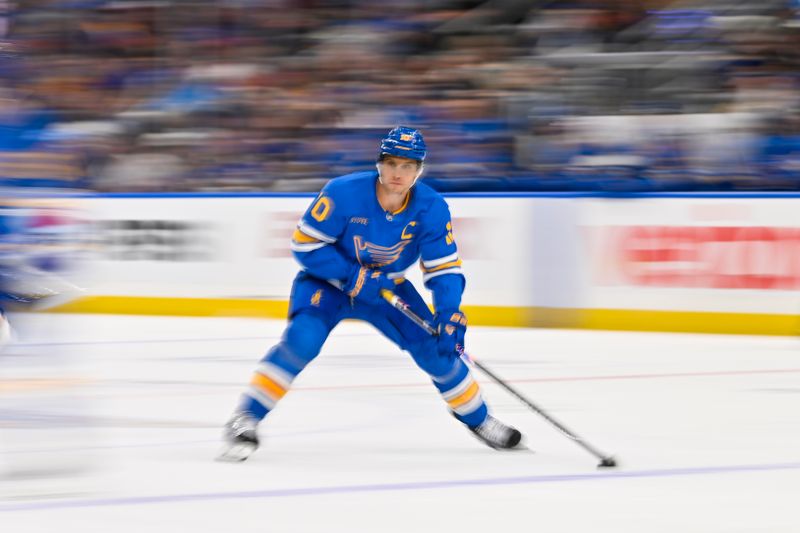 Oct 15, 2025; St. Louis, Missouri, USA; St. Louis Blues center Brayden Schenn (10) controls the puck against the Chicago Blackhawks during the third period at Enterprise Center. Mandatory Credit: Jeff Curry-Imagn Images