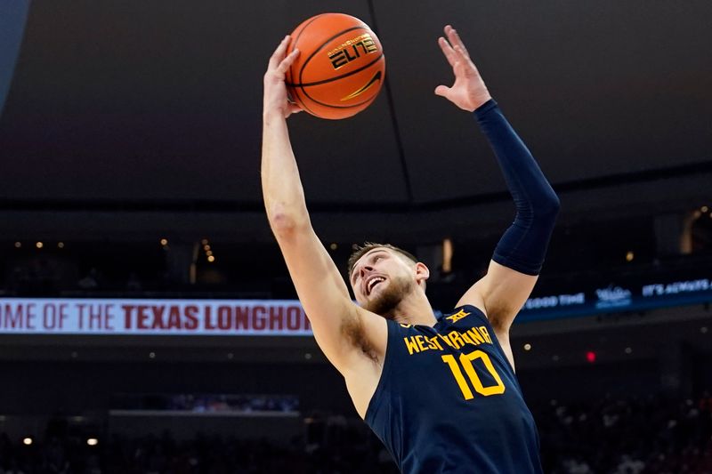 Feb 11, 2023; Austin, Texas, USA; West Virginia Mountaineers guard Erik Stevenson (10) grabs a rebound during the first half against the Texas Longhorns at Moody Center. Mandatory Credit: Scott Wachter-USA TODAY Sports