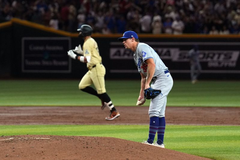 Aug 31, 2024; Phoenix, Arizona, USA; Los Angeles Dodgers pitcher Gavin Stone (35) reacts after giving up a solo home run to Arizona Diamondbacks outfielder Lourdes Gurriel Jr. (12) during the third inning at Chase Field. Mandatory Credit: Joe Camporeale-USA TODAY Sports