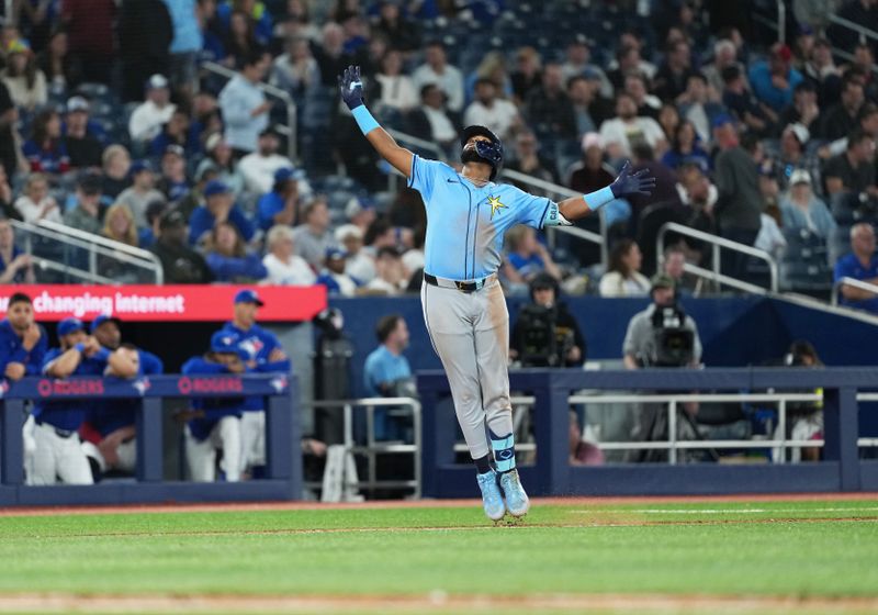 May 13, 2025; Toronto, Ontario, CAN; Tampa Bay Rays third baseman Junior Caminero (13) celebrates hitting a grand slam home run against the Toronto Blue Jays during the ninth inning at Rogers Centre. Mandatory Credit: Nick Turchiaro-Imagn Images