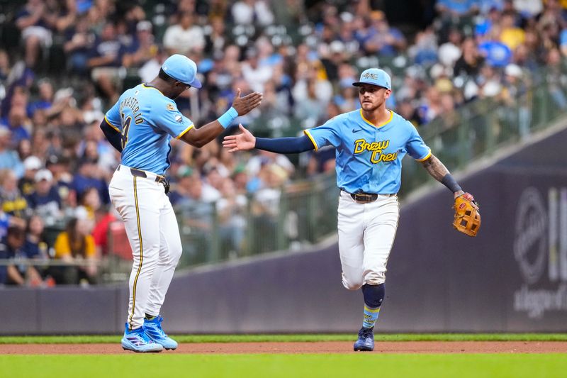 Sep 26, 2025; Milwaukee, Wisconsin, USA;  Milwaukee Brewers shortstop Joey Ortiz (3) is congratulated by Andruw Monasterio (14) following the final out of the eighth inning against the Cincinnati Reds at American Family Field. Mandatory Credit: Jeff Hanisch-Imagn Images