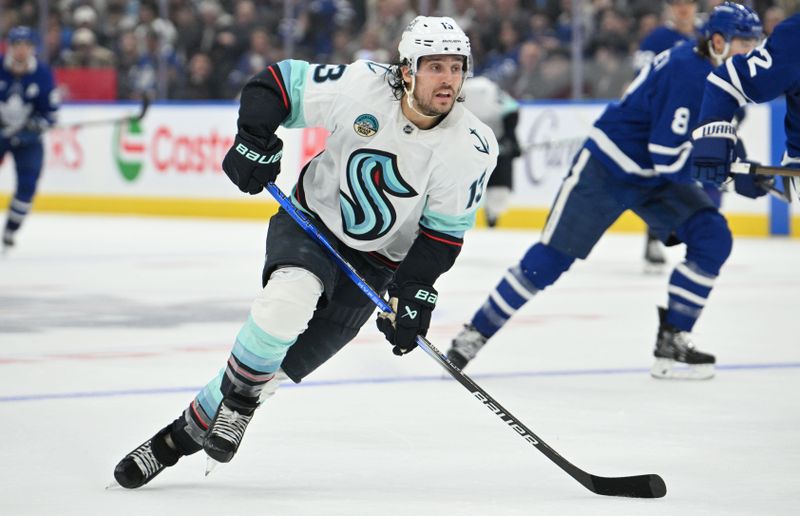 Oct 31, 2024; Toronto, Ontario, CAN;  Seattle Kraken forward Brandon Tanev (13) pursues the play against the Toronto Maple Leafs in the second period at Scotiabank Arena. Mandatory Credit: Dan Hamilton-Imagn Images