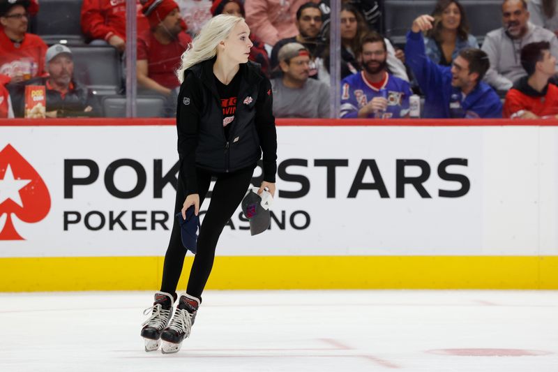 Oct 17, 2024; Detroit, Michigan, USA;  Detroit Red Wings ice crew pick up hats after New York Rangers left wing Artemi Panarin (not pictured) scores a hat trick in the second period against the Detroit Red Wings at Little Caesars Arena. Mandatory Credit: Rick Osentoski-Imagn Images