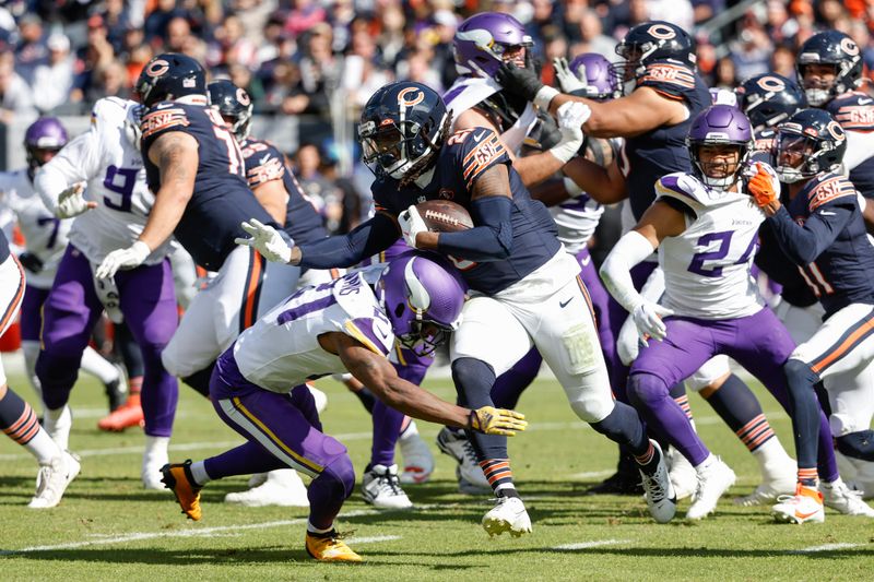 Chicago Bears running back D'Onta Foreman (21) is tackled by Minnesota Vikings cornerback Akayleb Evans (21) during the first half of an NFL football game, Sunday, Oct. 15, 2023, in Chicago. (AP Photo/Kamil Krzaczynski)