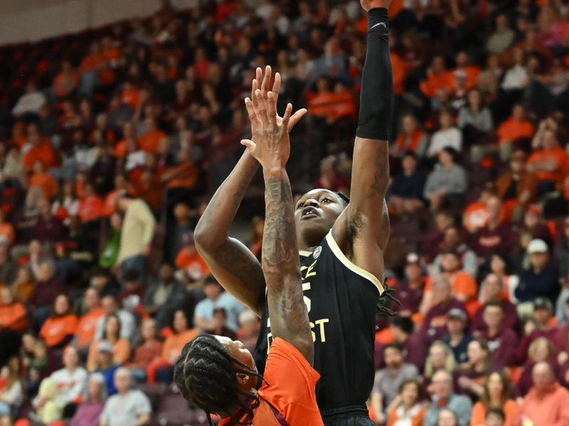 Feb 21, 2026; Blacksburg, Virginia, USA;  Wake Forest Demon Deacons forward Tre'von Spillers (25) shoots a shot defended by Virginia Tech Hokies forward Tobi Lawal (1) during the first half at Cassell Coliseum. Mandatory Credit: Brian Bishop-Imagn Images