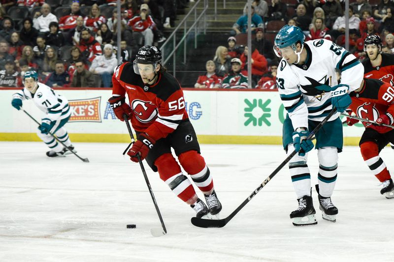 Nov 10, 2024; Newark, New Jersey, USA; New Jersey Devils left wing Erik Haula (56) skates with the puck against San Jose Sharks center Ty Dellandrea (53) during the third period at Prudential Center. Mandatory Credit: John Jones-Imagn Images