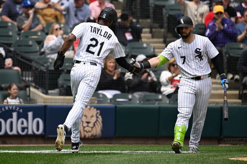 Jun 5, 2025; Chicago, Illinois, USA;  Chicago White Sox outfielder Michael A. Taylor (21) high fives  catcher Edgar Quero (7) after he scores against the Detroit Tigers during the fourth inning at Rate Field. Mandatory Credit: Matt Marton-Imagn Images