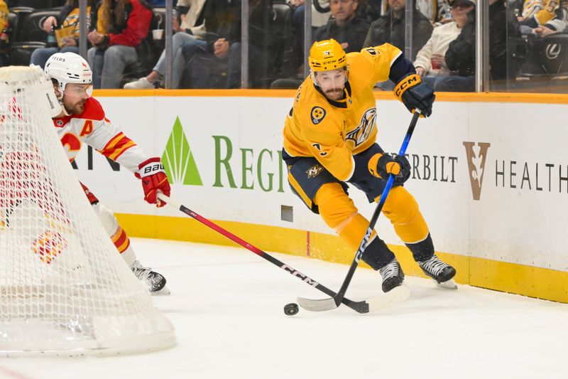 Dec 2, 2025; Nashville, Tennessee, USA;  Nashville Predators left wing Filip Forsberg (9) skates behind the net against the Calgary Flames during the first period at Bridgestone Arena. Mandatory Credit: Steve Roberts-Imagn Images