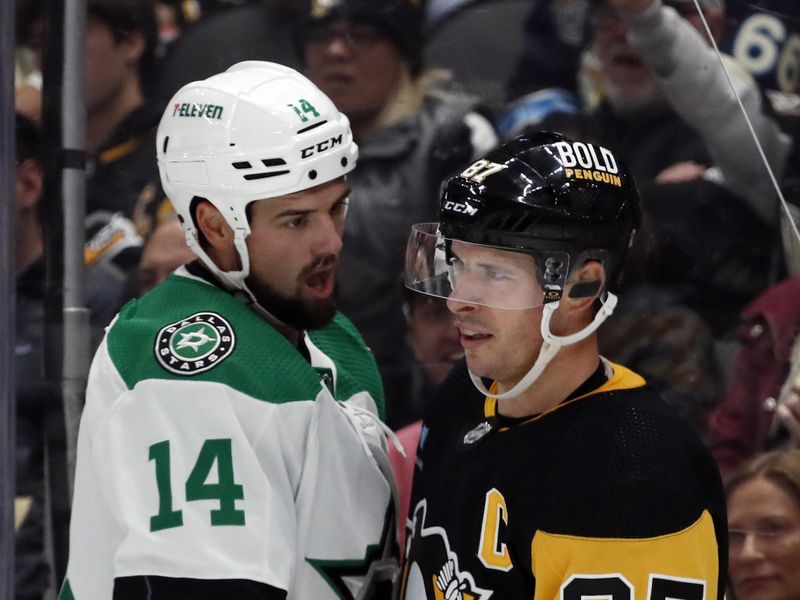 Oct 24, 2023; Pittsburgh, Pennsylvania, USA; Dallas Stars left wing Jamie Benn (14) reacts to Pittsburgh Penguins center Sidney Crosby (87) during the second period at PPG Paints Arena. Dallas won 4-1. Mandatory Credit: Charles LeClaire-USA TODAY Sports