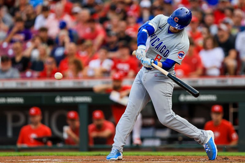 Jul 29, 2024; Cincinnati, Ohio, USA; Chicago Cubs outfielder Ian Happ (8) hits a single in the first inning against the Cincinnati Reds at Great American Ball Park. Mandatory Credit: Katie Stratman-USA TODAY Sports