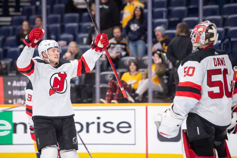 Feb 13, 2024; Nashville, Tennessee, USA; New Jersey Devils center Curtis Lazar (42) celebrates the win with goaltender Nico Daws (50) against the Nashville Predators  during the third period at Bridgestone Arena. Mandatory Credit: Steve Roberts-USA TODAY Sports