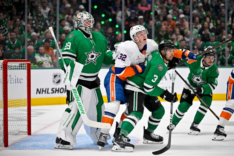 Oct 12, 2024; Dallas, Texas, USA; New York Islanders center Kyle MacLean (32) skates between Dallas Stars goaltender Jake Oettinger (29) and defenseman Matt Dumba (3) during the first period at the American Airlines Center. Mandatory Credit: Jerome Miron-Imagn Images