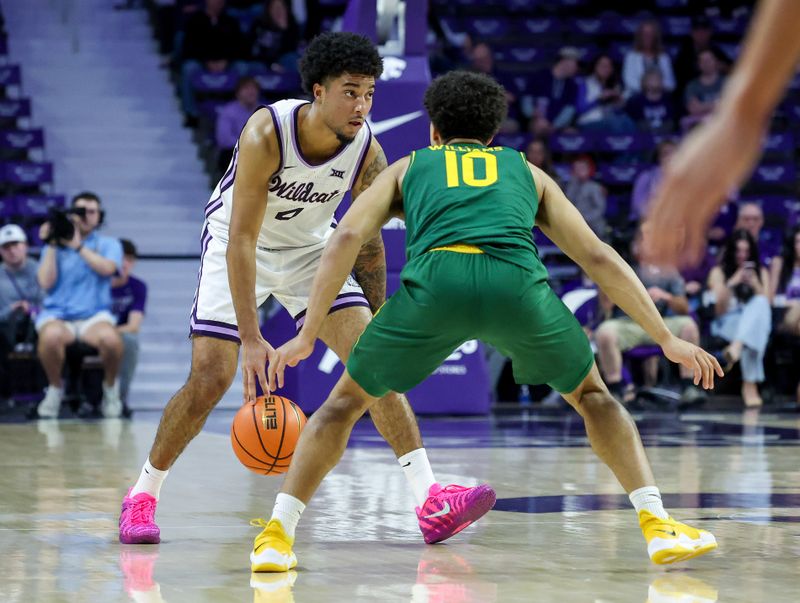 Feb 17, 2026; Manhattan, Kansas, USA; Kansas State Wildcats guard P.J. Haggerty (4) is guarded by Kansas State Wildcats guard David Castillo (10) during the first half at Bramlage Coliseum. Mandatory Credit: Scott Sewell-Imagn Images