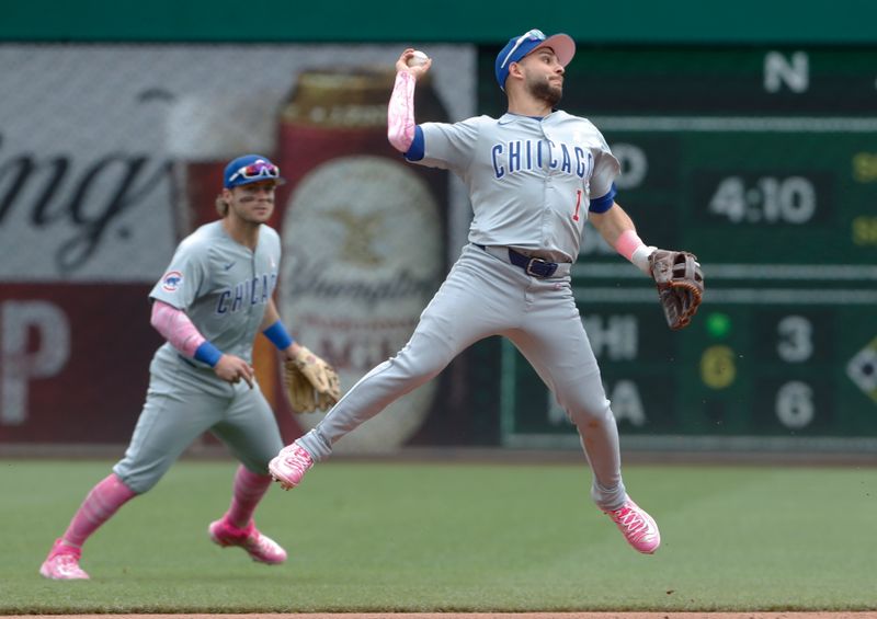 May 12, 2024; Pittsburgh, Pennsylvania, USA;  Chicago Cubs second baseman Nick Madrigal (1) throws to first base too late to retire Pittsburgh Pirates center fielder Jack Suwinski (not pictured) during the sixth inning  against at PNC Park. Mandatory Credit: Charles LeClaire-USA TODAY Sports