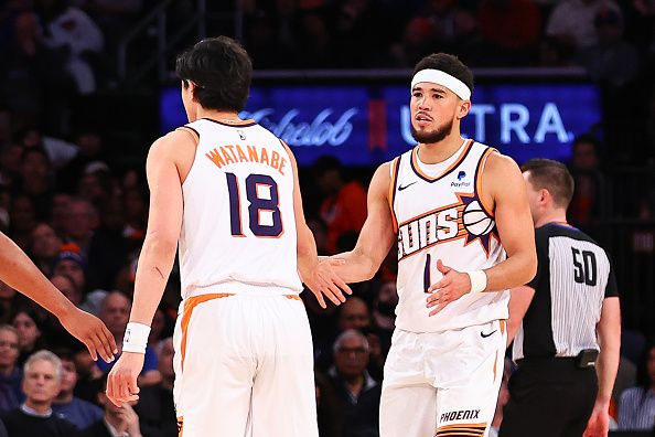 NEW YORK, NY - NOVEMBER 26:  Yuta Watanabe #18 of the Phoenix Suns and Devin Booker #1  during the game against the New York Knicks at Madison Square Garden on November 26, 2023 in New York City.  NOTE TO USER: User expressly acknowledges and agrees that, by downloading and or using this photograph, User is consenting to the terms and conditions of the Getty Images License Agreement. (Photo by Rich Graessle/Getty Images)