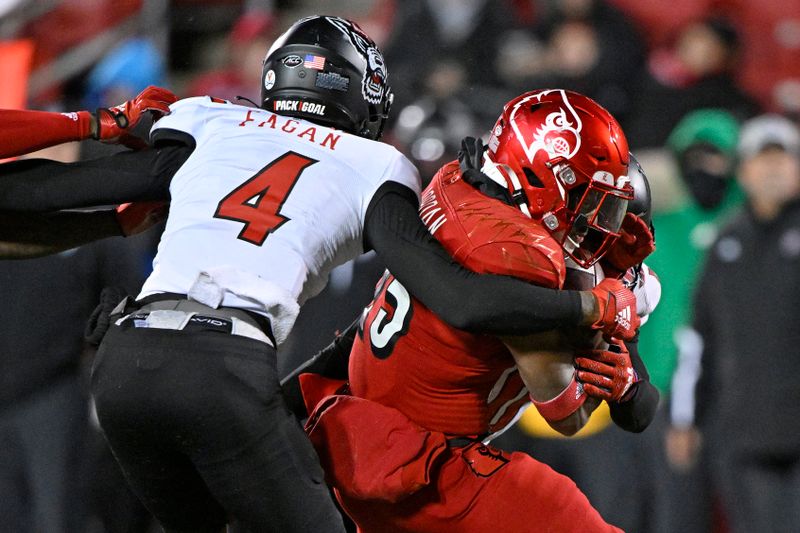 Nov 19, 2022; Louisville, Kentucky, USA; Louisville Cardinals running back Jawhar Jordan (25) runs the ball against North Carolina State Wolfpack safety Cyrus Fagan (4) during the second half at Cardinal Stadium. Louisville defeated North Carolina State 25-10. Mandatory Credit: Jamie Rhodes-USA TODAY Sports