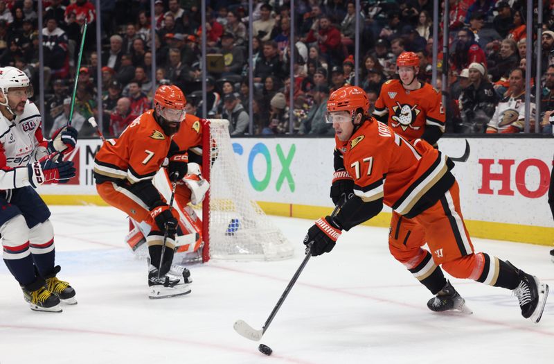 Mar 11, 2025; Anaheim, California, USA; Anaheim Ducks right wing Frank Vatrano (77) skates with the puck against Washington Capitals left wing Alex Ovechkin (8) during the first period at Honda Center. Mandatory Credit: Jason Parkhurst-Imagn Images