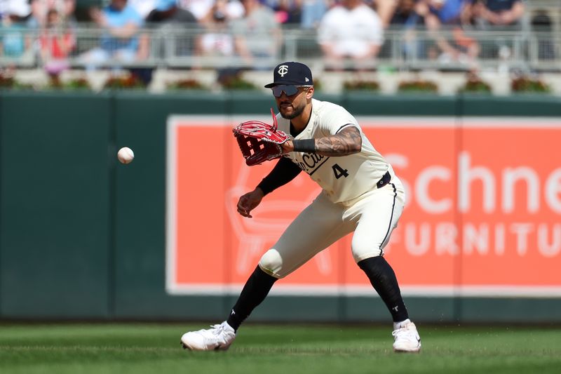Apr 10, 2024; Minneapolis, Minnesota, USA; Minnesota Twins shortstop Carlos Correa (4) fields the ball hit by Los Angeles Dodgers second baseman Mookie Betts (not pictured) during the seventh inning at Target Field. Mandatory Credit: Matt Krohn-USA TODAY Sports