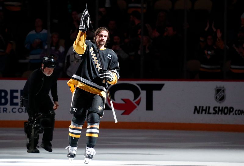 Apr 11, 2024; Pittsburgh, Pennsylvania, USA; Pittsburgh Penguins defenseman Erik Karlsson (65) reacts to being named first star of the game after scoring the game winning goal against the Detroit Red Wings in overtime at PPG Paints Arena. Pittsburgh won 6-5 in overtime. Mandatory Credit: Charles LeClaire-USA TODAY Sports