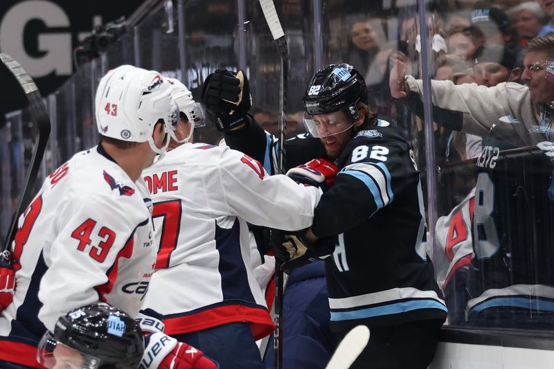 Nov 18, 2024; Salt Lake City, Utah, USA; Washington Capitals center Dylan Strome (17) and Utah Hockey Club center Logan Cooley (92) fight during the second period at Delta Center. Mandatory Credit: Rob Gray-Imagn Images