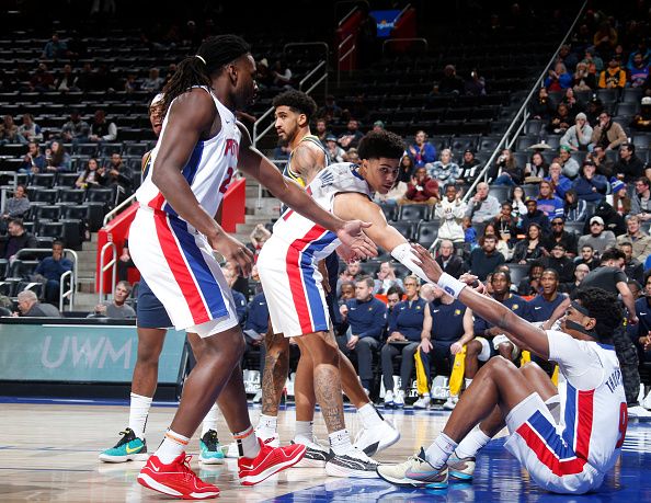DETROIT, MI - DECEMBER 11: Ausar Thompson #9 of the Detroit Pistons is helped up by Isaiah Stewart #28 and Killian Hayes #7 during the game against the Indiana Pacers on December 11, 2023 at Little Caesars Arena in Detroit, Michigan. NOTE TO USER: User expressly acknowledges and agrees that, by downloading and/or using this photograph, User is consenting to the terms and conditions of the Getty Images License Agreement. Mandatory Copyright Notice: Copyright 2023 NBAE (Photo by Brian Sevald/NBAE via Getty Images)