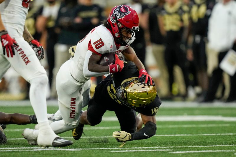 Nov 11, 2023; Winston-Salem, North Carolina, USA; North Carolina State Wolfpack wide receiver Kevin Concepcion (10) is tackled by Wake Forest Demon Deacons linebacker Chase Jones (21) during the second half at Allegacy Federal Credit Union Stadium. Mandatory Credit: Jim Dedmon-USA TODAY Sports