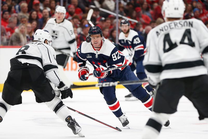 Jan 7, 2024; Washington, District of Columbia, USA; Washington Capitals center Evgeny Kuznetsov (92) battles for the puck with Los Angeles Kings defenseman Drew Doughty (8) during the second period at Capital One Arena. Mandatory Credit: Amber Searls-USA TODAY Sports