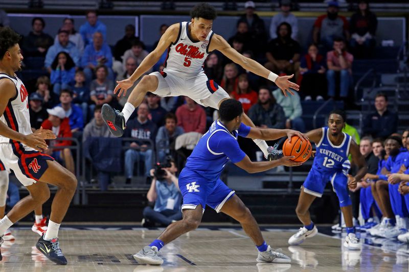 Jan 31, 2023; Oxford, Mississippi, USA; Mississippi Rebels guard James White (5) defends Kentucky Wildcats guard Sahvir Wheeler (2) as he passes the ball during the second half at The Sandy and John Black Pavilion at Ole Miss. Mandatory Credit: Petre Thomas-USA TODAY Sports