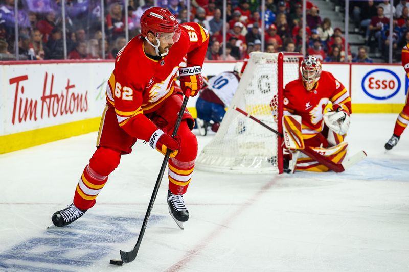 Mar 14, 2025; Calgary, Alberta, CAN; Calgary Flames defenseman Daniil Miromanov (62) controls the puck against the Colorado Avalanche during the first period at Scotiabank Saddledome. Mandatory Credit: Sergei Belski-Imagn Images