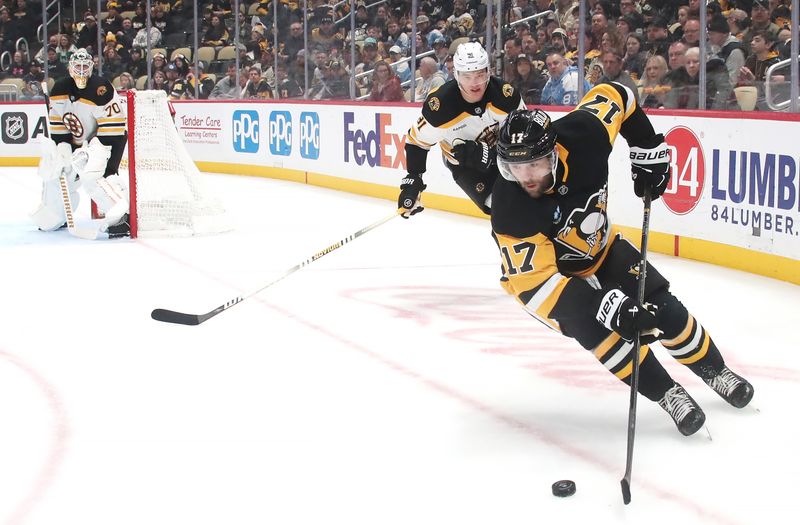 Mar 1, 2025; Pittsburgh, Pennsylvania, USA;  Pittsburgh Penguins right wing Bryan Rust (17) moves the puck against the Boston Bruins during the third period at PPG Paints Arena. Mandatory Credit: Charles LeClaire-Imagn Images