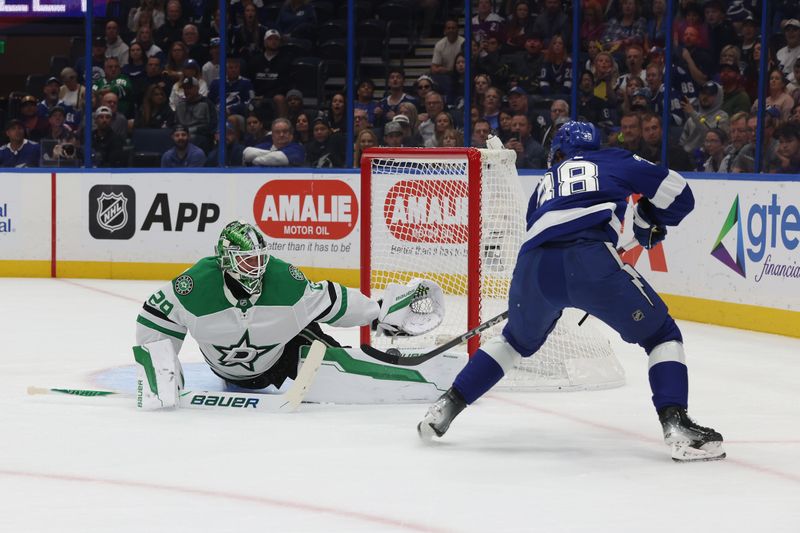 Oct 30, 2025; Tampa, Florida, USA; Tampa Bay Lightning left wing Brandon Hagel (38) shoots on goal as Dallas Stars goaltender Jake Oettinger (29) makes a save during the first period at Benchmark International Arena. Mandatory Credit: Kim Klement Neitzel-Imagn Images