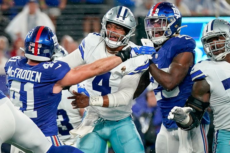 Dallas Cowboys quarterback Dak Prescottbattles with New York Giants defenders during the first half of an NFL football game, Sunday, Sept. 10, 2023, in East Rutherford, N.J. (AP Photo/Bryan Woolston)