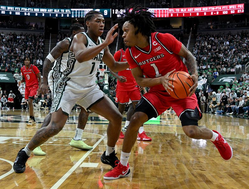 Mar 5, 2026; East Lansing, Michigan, USA;  Michigan State Spartans guard Jeremy Fears Jr. (1) defends on Rutgers Scarlet Knights guard Jamichael Davis (1) during the first half at Jack Breslin Student Events Center. Mandatory Credit: Dale Young-Imagn Images