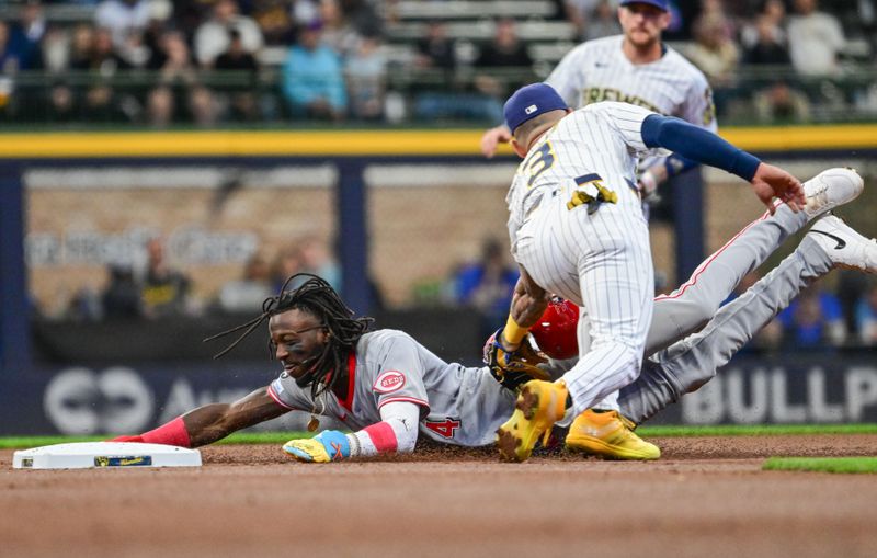 Apr 6, 2025; Milwaukee, Wisconsin, USA; Cincinnati Reds shortstop Elly De La Cruz (44) is tagged out by Milwaukee Brewers shortstop Joseph Ortiz (3) trying to steal second base in the first inning at American Family Field. Mandatory Credit: Benny Sieu-Imagn Images