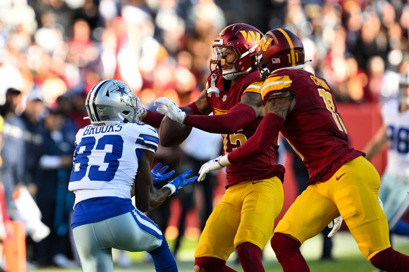 Dallas Cowboys wide receiver Jalen Brooks (83) catches the ball against Washington Commanders cornerback Benjamin St-Juste during the first half of an NFL football game, Sunday, Nov. 24, 2024, in Landover, Md. (AP Photo/Terrance Williams)