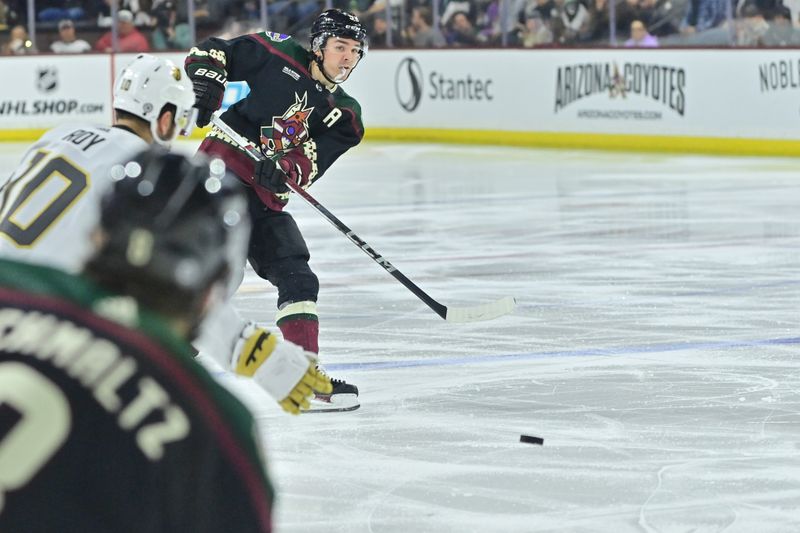 Feb 8, 2024; Tempe, Arizona, USA;  Arizona Coyotes right wing Clayton Keller (9) passes to center Nick Schmaltz (8) in the second period against the Vegas Golden Knights at Mullett Arena. Mandatory Credit: Matt Kartozian-USA TODAY Sports