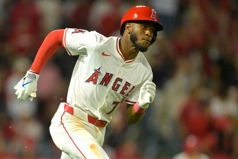 Apr 5, 2025; Anaheim, California, USA;  Los Angeles Angels shortstop Tim Anderson (77) runs to first on a two RBI double in the fifth inning against the Cleveland Guardians at Angel Stadium. Mandatory Credit: Jayne Kamin-Oncea-Imagn Images