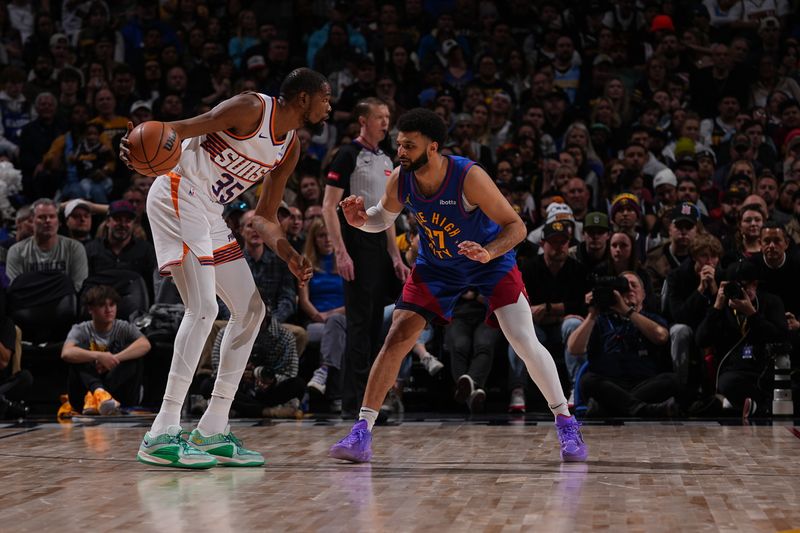 DENVER, CO - MARCH 5: Kevin Durant #35 of the Phoenix Suns handles the ball against Jamal Murray #27 of the Denver Nuggets during the game on March 5, 2024 at the Ball Arena in Denver, Colorado. NOTE TO USER: User expressly acknowledges and agrees that, by downloading and/or using this Photograph, user is consenting to the terms and conditions of the Getty Images License Agreement. Mandatory Copyright Notice: Copyright 2024 NBAE (Photo by Bart Young/NBAE via Getty Images)