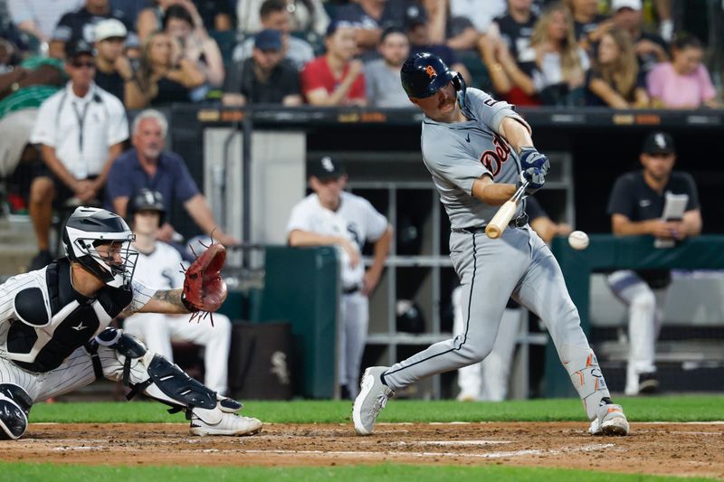 Aug 24, 2024; Chicago, Illinois, USA; Detroit Tigers catcher Jake Rogers (34) hits a two-run single against the Chicago White Sox during the fourth inning at Guaranteed Rate Field. Mandatory Credit: Kamil Krzaczynski-USA TODAY Sports